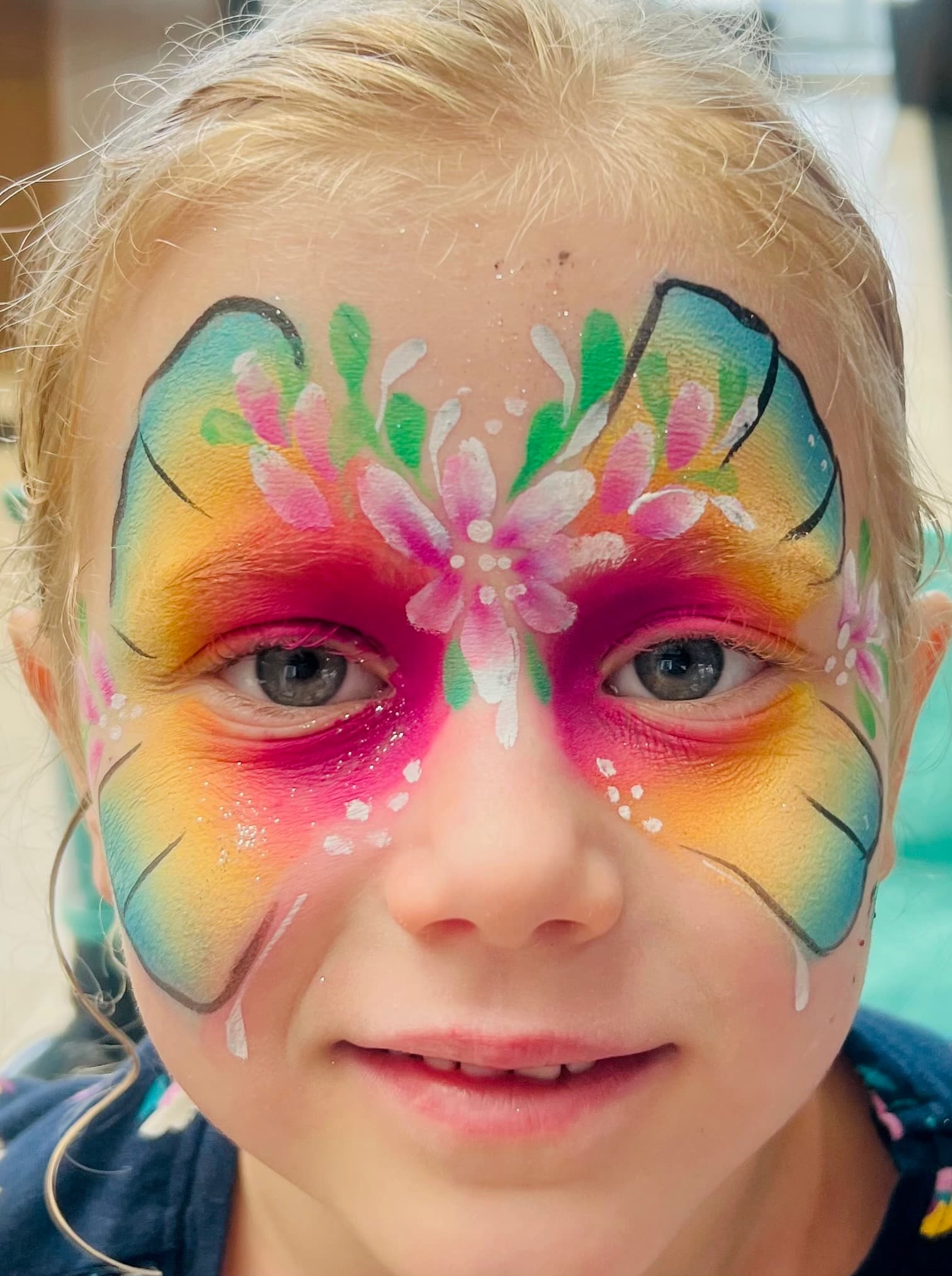 Colorful butterfly face painting on child